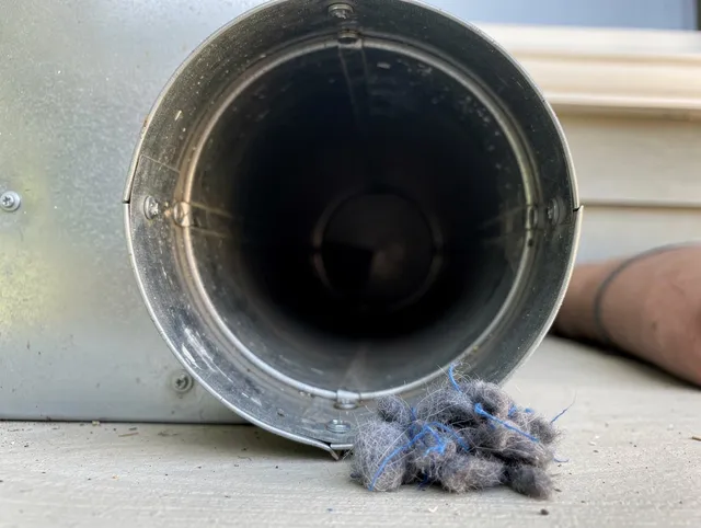 Fort Collins Dryer Vent Cleaning technician using specialized equipment to clear severe dryer vent blockage in Fort Collins